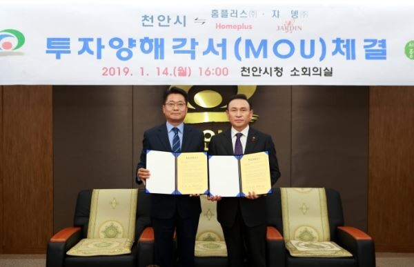 ▲전화수 홈플러스 운영지원부문장(전무·왼쪽)과 구본영 천안시장(오른쪽)이 지난 14일 오후 충청남도 천안시 불당동 천안시청에서 대규모 ‘미트센터(Meat Center)’ 건립을 위한 투자협약(MOU)을 체결한 후 협약서를 들어보이고 있다. [사진=홈플러스]