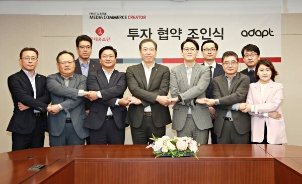 ▲롯데홈쇼핑은 1일 양평동 본사에서 미디어커머스 스타트업 '어댑트'에 직접 투자하는 업무 협약식을 진행했다. 이날 참석한 관계자들이 기념 사진을 촬영하는 모습.                 (사진 앞줄 왼쪽부터) 김재겸 롯데홈쇼핑 지원본부장, 김종영 롯데홈쇼핑 마케팅부문장, 김인호 롯데홈쇼핑 DT본부장, 이완신 롯데홈쇼핑 대표, 박정하 어댑트 대표, 민호 어댑트 재무부문 전무, 임효선 어댑트 마케팅팀장, 뒷줄 왼쪽부터 신성빈 롯데홈쇼핑 기획부문장, 조성운 어댑트 상품기획부장, 이용우 어댑트 인사총무팀장 . [사진=롯데홈쇼핑]